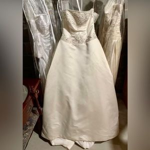 With tag store sample (size 10) wedding gown. Color is ivory/candle light